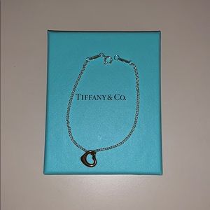 Tiffany’s bracelet. Silver chain with gold heart.